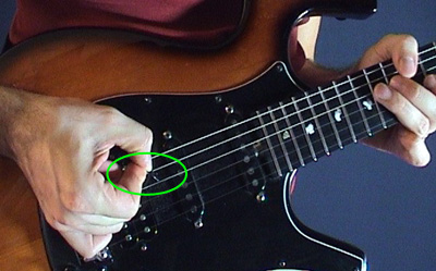 How do you hold a guitar pick?